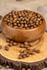 chickpeas on the table, fried chickpeas are on the table with a linen tablecloth, porridge is poured in a wooden bowl, side view