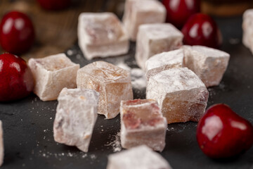 cubes of Turkish delight with the addition of berries in powdered sugar