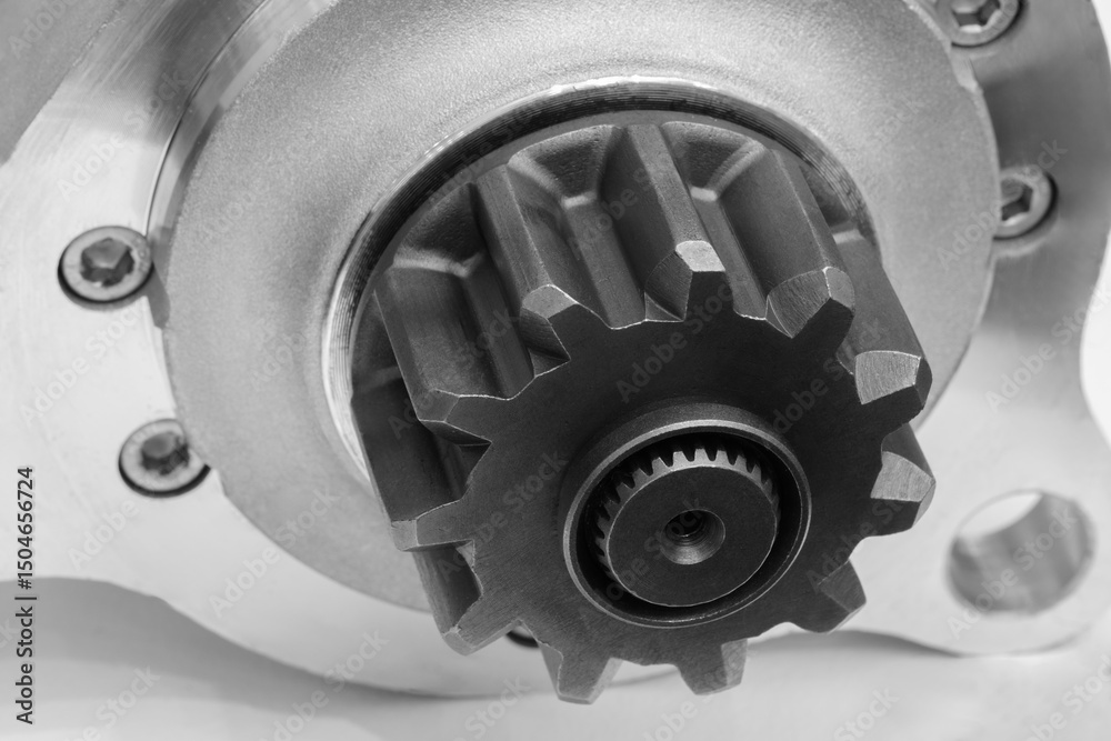 Poster a close up of a gear with a black center. the gear is part of a machine and is in the process of bei