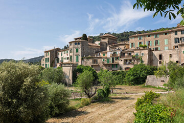 Obraz premium Valldemossa showing traditional stone houses with green shutters in majorca, spain
