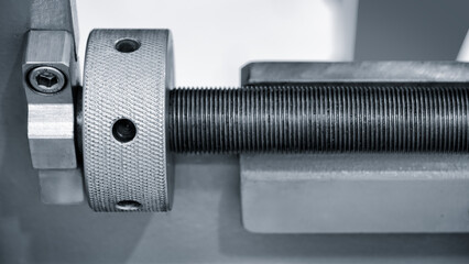 Screw drive as part of industrial machine or conveyor, industrial concept background