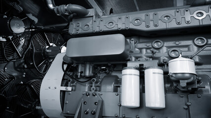 A large engine with many parts is shown in a factory. The engine is made of metal and has a lot of...