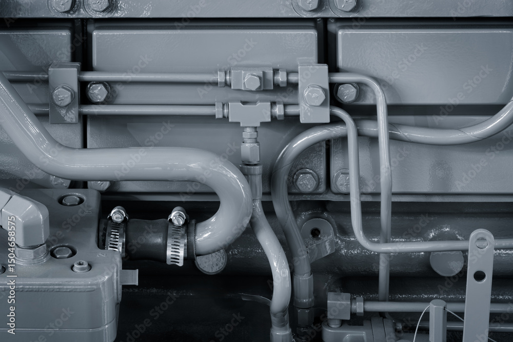 Poster a close up of a piece of machinery with a lot of bolts and pipes. concept of complexity and intricac
