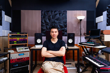 asian professional male music producer, sound engineer, songwriter, arranger, composer posing in home recording studio. music production concept