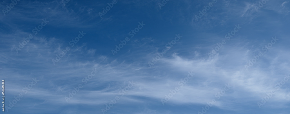 Poster the sky is blue with white clouds. the clouds are fluffy and scattered. the sky is clear and bright.