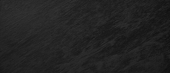 A black background with no visible objects. The background is dark and has a rough texture