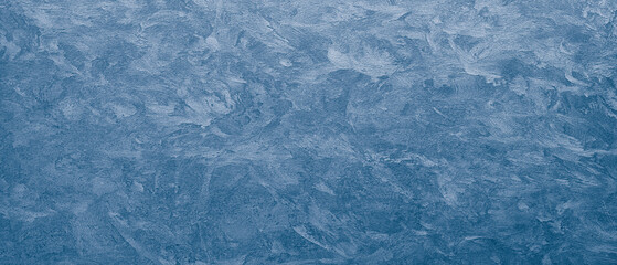 A blue wall with a textured surface. rough texture as an abstract texture background for template pages and banners