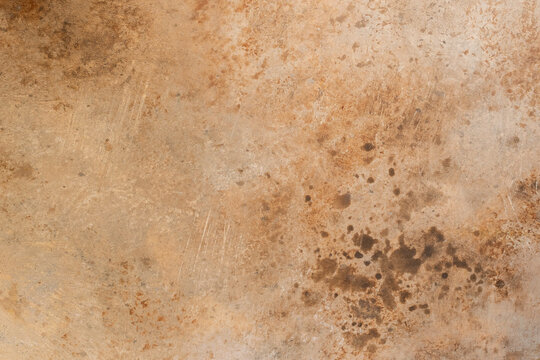 Textured rusty metal surface with brown and orange corrosion patterns