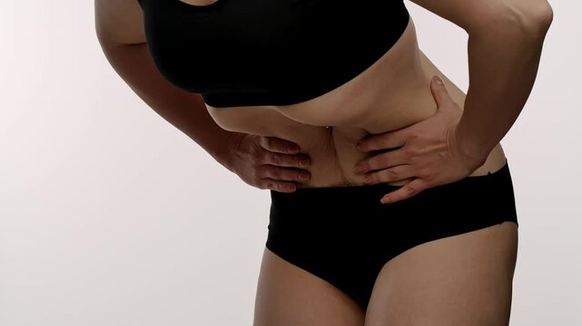 Woman in Black Lingerie Doing Stomach Vacuum Technique