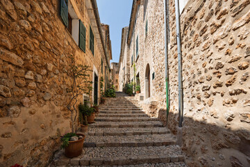 Stone stairs climbing through narrow street in fornalutx, mallorca