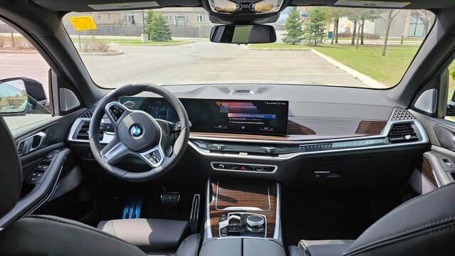 Ottawa, ON Canada - 04.22.2023: Luxurious BMW X5 Vehicle Interior Displaying Advanced Technology and Elegant Wood Trim Design Elements