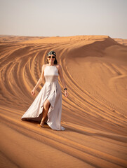 Beautiful girls in a beautiful flowing dress in desert condition