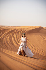 Beautiful girls in a beautiful flowing dress in desert condition