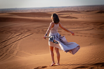Beautiful girls in a beautiful flowing dress in desert condition