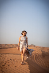 Beautiful girls in a beautiful flowing dress in desert condition