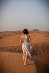 Beautiful girls in a beautiful flowing dress in desert condition
