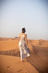 Beautiful girls in a beautiful flowing dress in desert condition