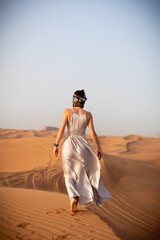 Beautiful girls in a beautiful flowing dress in desert condition