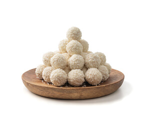 Coconut candies pile, coco ball. White truffle ball, indian ladoo or laddu with sweet cream