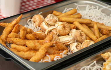 Deep fry seafood set with calamari rings, crispy gyoza dumplings, shrimps and spring rolls