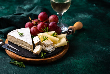 Different types of cheese, wine and grapes