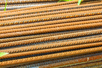 Horizontal stack of steel reinforcement bars showing parallel lines and industrial construction materials