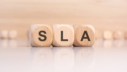 SLA abbreviation on wooden blocks with reflection on glossy surface