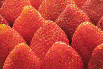 Close-up of strawberries arranged in diagonal rows.