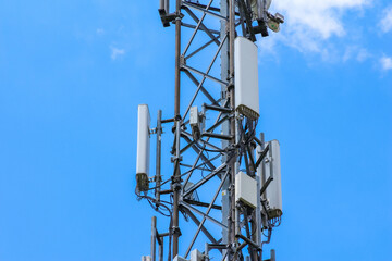 Close-up view of cellular phone tower antenna equipment mounted on metal lattice structure