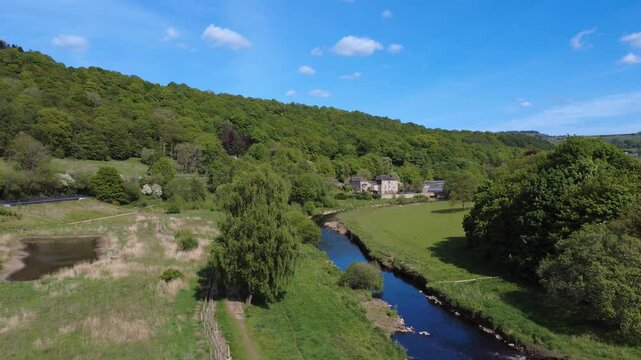 scenic aerial drone shot of the river calder at Brearley fields wetlands between mytholmroyd and Luddenden Foot surrounded by west yorkshire scenery in summer