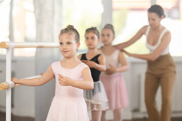 Lesson for little ballerinas - girls learn to dance ballet in a choreographic class © JackF