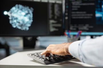 Close up of data center engineer using artificial intelligence visualization tools on PC to...