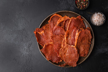 pork dried chips on a black background