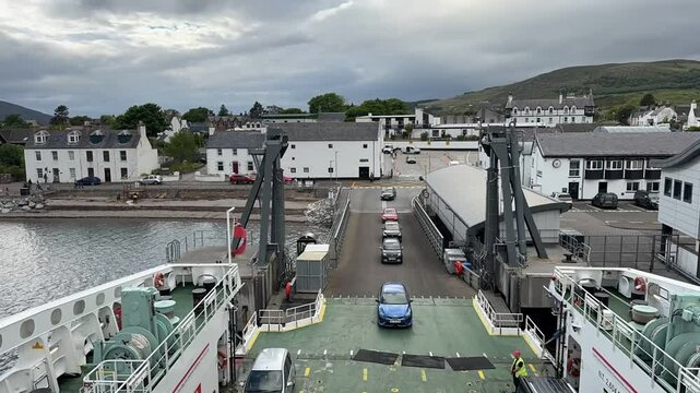 Timelapse of cars and passengers loading onto a CalMac ferry at Ullapool harbour for the boat crossing to Stornoway, Outer Hebrides, Scotland