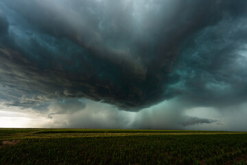Rainstorm fills the sky as powerful dark storm clouds loom