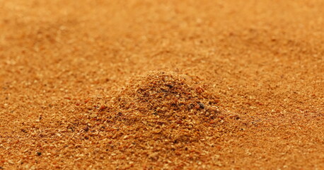 Milled nutmeg pile, powder background and texture, side view	