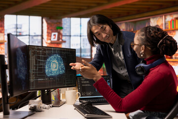 CTO manager in multiethnic startup office helps technician coding advanced AI algorithm and machine...