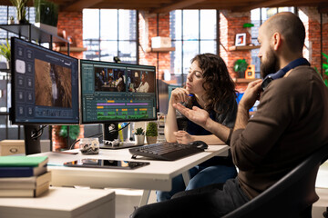 Creative couple working together on video editing software for movie making, using AI powered...