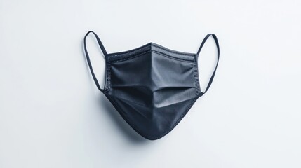 Black reusable face mask, isolated on a crisp white background, symbolizing sustainability and cleanliness