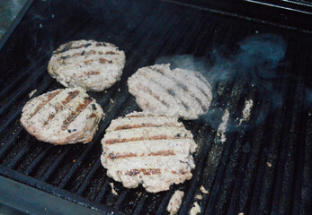Burgers on a hot gas grill.