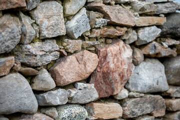 The many colours and textures of a traditionally constructed rock wall.