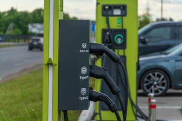 Electric Vehicle Charging Station with Multiple Cables Providing Power to Cars