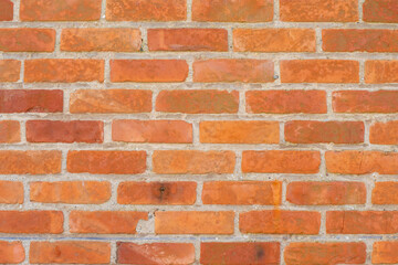 Brick wall in different shades of red and orange, Spoon masonry in half brick, attractive textured background in rustic style, aged surface,