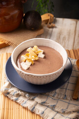 Refried bean soup. In Mexico known as Crema de Frijoles, nutritious homemade food recipe, commonly accompanied with cheese, cream, avocado and corn tortilla cut into strips and fried.