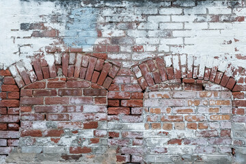 old painted brick wall with arches