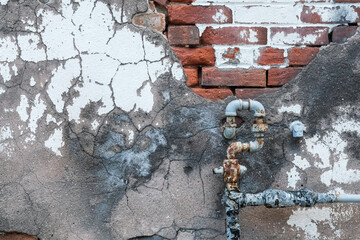 rusty metal pipe and brick background