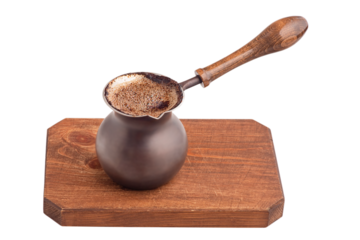 Ready coffee in a Turk on a brown wooden board, isolate.