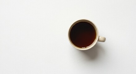 a cup of coffee on a white surface