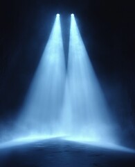Two bright spotlights shining down through mist or smoke in a dark empty space, creating beams of blue light and a moody atmosphere