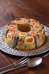 Shrimp couscous with tomato sauce, shrimp, eggs and sardines